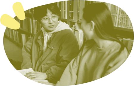 Photo of two young people together in a library